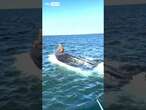 A fisherman has saved a man stuck on a capsized boat.