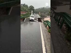Car falls from collapsing bridge into raging river in China
