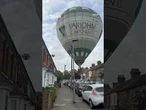 Horror moment hot air balloon crash lands in street before deflating over homes & cars