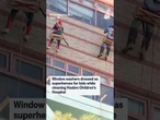 Window washers dressed as superheroes for kids while cleaning Hasbro Children's Hospital