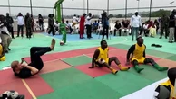 Harry plays sitting volleyball as Meghan cheers him on in Nigeria