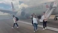 Passengers evacuate American Airlines flight after wheel catches fire