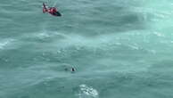 Hurricane Milton: Watch US Coast Guard rescue man clinging to ice box