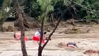 Residents cling to rope as Texas floodwater surges around them