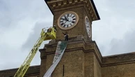 Video: Moment activist clutching dog scales London station