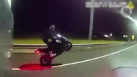 Speeding biker performs wheelie not realising police are behind him