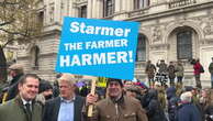 Jenrick poses under ‘Starmer the farmer harmer’ sign