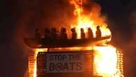 Life-size mannequins in migrant boat burn on Northern Ireland bonfire