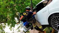 Woman rescued after crash leaves Porsche dangling from Florida garage