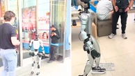 Humanoid robot tries on sneakers at Manhattan store