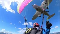 Plane crashes into paraglider and sends her spiraling through the air