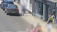 Police officer tackles knifeman on busy street in daytime brawl