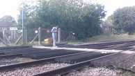 Watch: Distracted teenager stops on train tracks to check phone