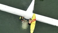 Pilot dragged out of submerged cockpit after landing near busy beach