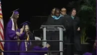 Student accidentally kicks girl doing backflip at graduation ceremony