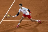 Djokovic battles to victory as he warms up for French Open