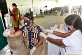 India pledges to distribute more vaccines as states extend lockdowns