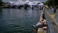Crowds flock to JR's giant cave installation on Paris' Pont Neuf