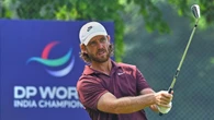 Tommy Fleetwood celebrates with son on 18th green after victory in Delhi