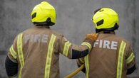 Firefighters battle blaze at shop and flats with people evacuated nearby