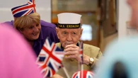 Veterans don Union flag hats and dance to 1940s tunes at VE Day street party