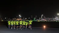 Joggers take off along runway in night-time airport fun run