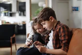 What age can you leave a child alone with a sibling in the summer school holidays?