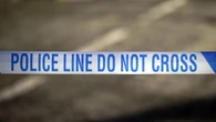 Teenager held on suspicion of murder after woman falls from block of flats