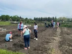 Athletes, students tend to community garden in support of Regina Foodbank