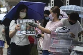 Hong Kong residents line up for final copy of pro-democracy tabloid Apple Daily