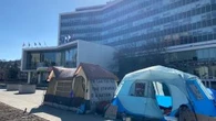 Tents pitched at Hamilton city hall prior to vote choosing parking lots over housing