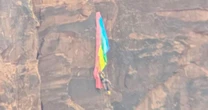 BASE jumper rescued after crashing into cliff and dangling from parachute in Utah
