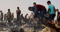 Israeli tanks reach central Rafah as Gazans search through charred remains of tent camp