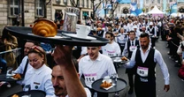Paris waiters race through the streets as French capital celebrates the city’s life and soul ahead of Olympics 