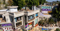 Two abandoned mansions owned by a Hollywood producer are covered in grafitti 