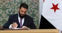 Syria's new leader signs constitution to keep his Islamist group in power for five years