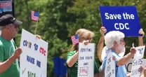 CDC staff and retired workers call for Kennedy’s resignation in a protest outside headquarters