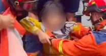 8-year-old girl pulled from sewer after 7 hours as floods batter southern China