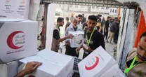 Israel halts aid, official says, as Palestinian clans in Gaza deny Hamas is stealing it