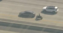 Motorcyclist wanted in connection with deputy's killing is stopped by off-duty officer during high-speed chase