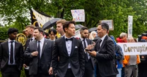 Outside Trump's meme coin dinner: Tuxedos, luxury SUVs and a protest