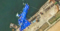 North Korea pulls capsized warship upright after botched launch, report says