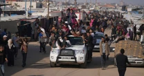 Dozens feared killed after Israeli tank fires on crowd waiting for aid in Gaza, witnesses say