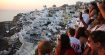 Greece’s Santorini bursts with tourists as locals call for a cap on visitors 