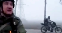 Russian forces ride into key Ukrainian city through fog on battered vehicles, video shows 