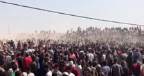 Crowds rush into aid distribution center in Gaza
