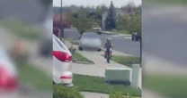 Driver arrested after video shows her hopping curb to chase child riding motorbike