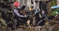 Four still remain trapped in the flooded Laos cave after one person was rescued