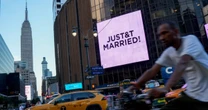 'Just Married' message appears on MSG video screen during Emilie Ikeda's report