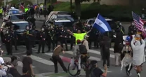 Reporter falls back with dispersed L.A. protesters amid flash-bangs, tear gas